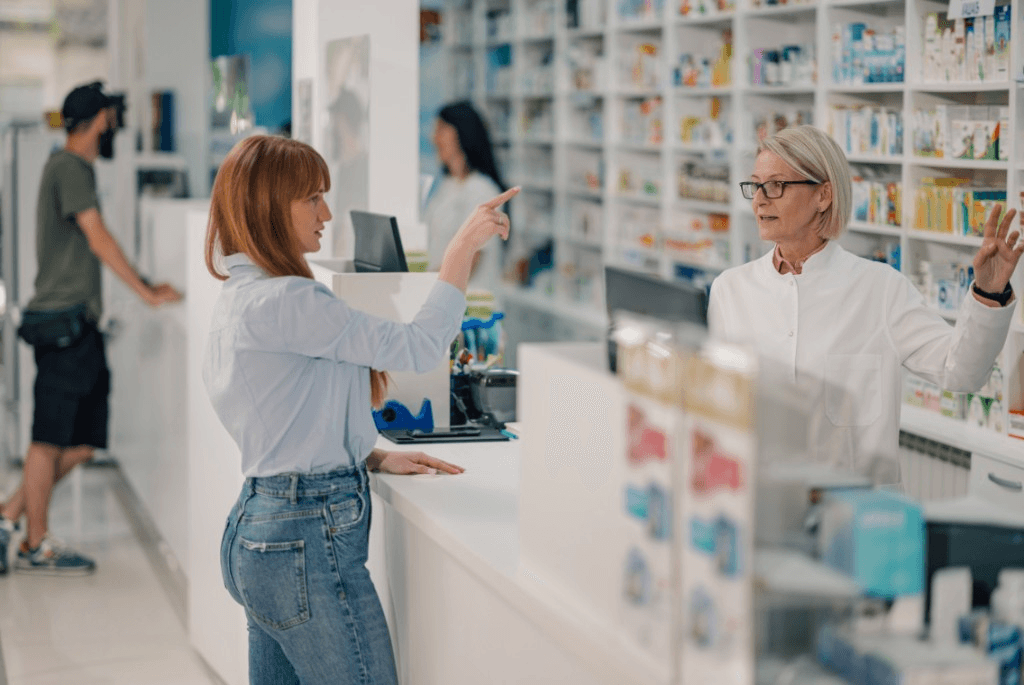 Pharmacist assisting a customer at the pharmacy counter