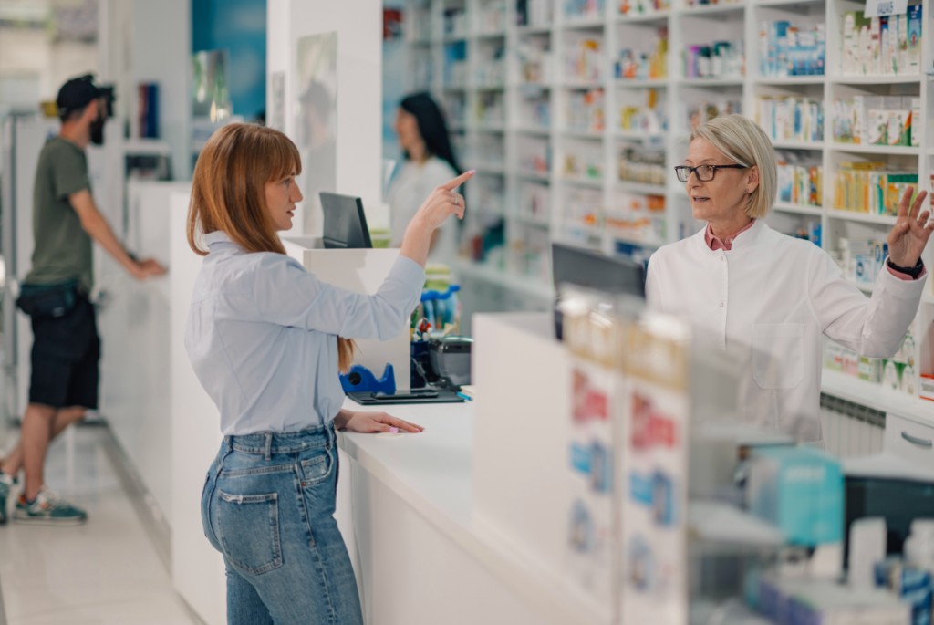 Pharmacist assisting a customer at the pharmacy counter